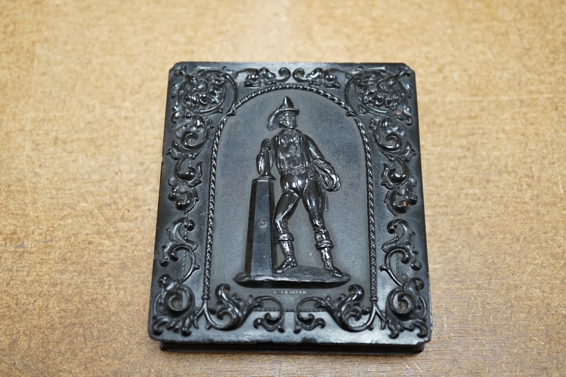 A mid Victorian ambrotype photograph of a gentleman, housed in an original pressed bois durci fireman frame, 9.5cm high. Condition - good